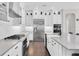 The kitchen features white cabinets, subway tile backsplash and stainless steel appliances at 6120 Marsh Trail Dr, Odessa, FL 33556