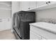 Well-organized laundry room featuring new washer/dryer, storage cabinets and sink at 6120 Marsh Trail Dr, Odessa, FL 33556