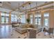 Spacious lounge with ample seating, stylish decor, and plenty of natural light throughout the room at 6120 Marsh Trail Dr, Odessa, FL 33556