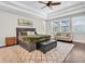 Bright main bedroom featuring a ceiling fan, rug, and cushioned bench at 6120 Marsh Trail Dr, Odessa, FL 33556