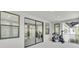 Covered patio with sliding glass doors and workout equipment at 6120 Marsh Trail Dr, Odessa, FL 33556