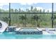 Luxurious pool featuring a spa, slide, and lush landscaping, creating a perfect oasis for relaxation and recreation at 6120 Marsh Trail Dr, Odessa, FL 33556
