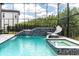 Gorgeous enclosed pool featuring a slide, spa, and elegant design, perfect for enjoying the outdoors in style at 6120 Marsh Trail Dr, Odessa, FL 33556