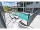 Beautiful screened-in pool and patio area features a slide, hot tub, and ample space for relaxing and entertaining at 6120 Marsh Trail Dr, Odessa, FL 33556