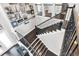 Elegant staircase with dark wood steps, wrought iron railings, and walls adorned with art at 6120 Marsh Trail Dr, Odessa, FL 33556