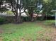 Sprawling backyard featuring mature trees and ground cover at 7240 Nova Scotia Dr, Port Richey, FL 34668
