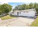 Well-maintained single-story home featuring a white exterior and spacious driveway at 7240 Nova Scotia Dr, Port Richey, FL 34668