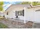 Front view of a charming ranch home with white brick exterior and covered porch at 7240 Nova Scotia Dr, Port Richey, FL 34668