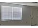 Bright living room with large window and blinds, offering natural light and privacy at 7240 Nova Scotia Dr, Port Richey, FL 34668