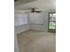 Sunlit room with tile floor, ceiling fan, and windows offering a bright and airy atmosphere at 7240 Nova Scotia Dr, Port Richey, FL 34668