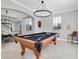 Entertain in this game room, complete with a pool table and stylish chandelier at 12135 Crestridge Loop, Trinity, FL 34655