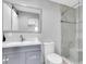 Modern bathroom with gray vanity, a walk-in shower, and a spacious layout at 12135 Crestridge Loop, Trinity, FL 34655