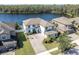 Aerial view of a two story house near a lake at 12135 Crestridge Loop, Trinity, FL 34655