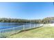 Lake view from the backyard with a white picket fence at 12135 Crestridge Loop, Trinity, FL 34655
