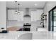Contemporary kitchen featuring a wood countertop island and white shaker cabinets at 12135 Crestridge Loop, Trinity, FL 34655