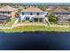Aerial view of a house backing up to a lake with a white fence at 12135 Crestridge Loop, Trinity, FL 34655