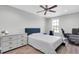 Bright bedroom with a comfortable bed, dresser, and ceiling fan at 12135 Crestridge Loop, Trinity, FL 34655