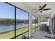 Screened porch with a ceiling fan and lake view, great for outdoor dining at 12135 Crestridge Loop, Trinity, FL 34655