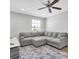 Living area with gray sectional sofa and area rug at 12135 Crestridge Loop, Trinity, FL 34655