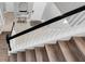 View of staircase from above, showing wood steps and black railing at 12135 Crestridge Loop, Trinity, FL 34655