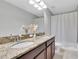 Double vanity bathroom with granite countertops and a shower/tub combo at 12135 Crestridge Loop, Trinity, FL 34655