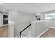 Upstairs hallway with light gray walls and wood floors at 12135 Crestridge Loop, Trinity, FL 34655