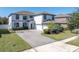 Two-story home with a paver driveway and basketball hoop at 12135 Crestridge Loop, Trinity, FL 34655