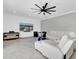 Relaxing living room with sectional sofa and large TV at 12135 Crestridge Loop, Trinity, FL 34655