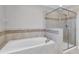 Bathroom with soaking tub and glass shower at 12135 Crestridge Loop, Trinity, FL 34655