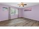 Spacious bedroom with light purple walls and wood-look flooring at 3018 Greynolds Ave, Spring Hill, FL 34608