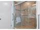 Walk-in shower with grab bars and tile surround at 3018 Greynolds Ave, Spring Hill, FL 34608