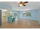 Dining room with light blue walls and view of the kitchen and pool at 3018 Greynolds Ave, Spring Hill, FL 34608