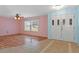 Bright living room with light pink walls and wood floors at 3018 Greynolds Ave, Spring Hill, FL 34608