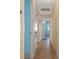 Bright hallway with tile flooring and access to multiple rooms at 3018 Greynolds Ave, Spring Hill, FL 34608