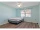 Spacious bedroom with wood-look flooring and ceiling fan at 3018 Greynolds Ave, Spring Hill, FL 34608