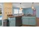 Kitchen with stainless steel appliances and light blue cabinets at 3018 Greynolds Ave, Spring Hill, FL 34608