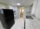 Bright kitchen with black appliances and tile floors at 5319 Whippoorwill Dr, Holiday, FL 34690