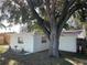 White house exterior with large tree and landscaping at 5319 Whippoorwill Dr, Holiday, FL 34690