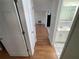 Clean hallway with light wood laminate flooring at 5319 Whippoorwill Dr, Holiday, FL 34690