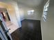 Living room with dark tile floors and access to kitchen at 5319 Whippoorwill Dr, Holiday, FL 34690