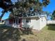 Side view of a ranch home with brick accents and landscaping at 5319 Whippoorwill Dr, Holiday, FL 34690