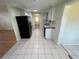 Kitchen features black appliances and tile flooring at 5319 Whippoorwill Dr, Holiday, FL 34690