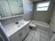 Updated bathroom with a tub, toilet, and vanity at 5319 Whippoorwill Dr, Holiday, FL 34690