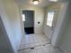Clean entryway with tile floors and access to rooms at 5319 Whippoorwill Dr, Holiday, FL 34690