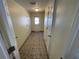Long hallway with tile floors and multiple doors at 5319 Whippoorwill Dr, Holiday, FL 34690