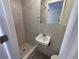 Small bathroom with shower stall and sink at 5319 Whippoorwill Dr, Holiday, FL 34690