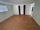 Large bedroom featuring wood-look laminate flooring and a closet at 5319 Whippoorwill Dr, Holiday, FL 34690