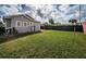 Spacious backyard with a gray house and wooden fence at 2321 W La Salle St, Tampa, FL 33607