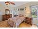 Cozy bedroom with hardwood floors and colorful bedding at 13517 Hunters Point St, Spring Hill, FL 34609