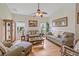 Relaxing living room with hardwood floors, comfy sofas, and wicker furniture at 13517 Hunters Point St, Spring Hill, FL 34609